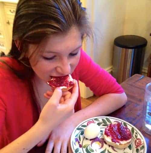 teen girl eating toast with jam