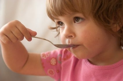 child eating off a spoon