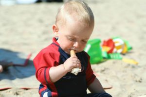 Baby eating an ice cream cone. Feeding mistakes with kids.