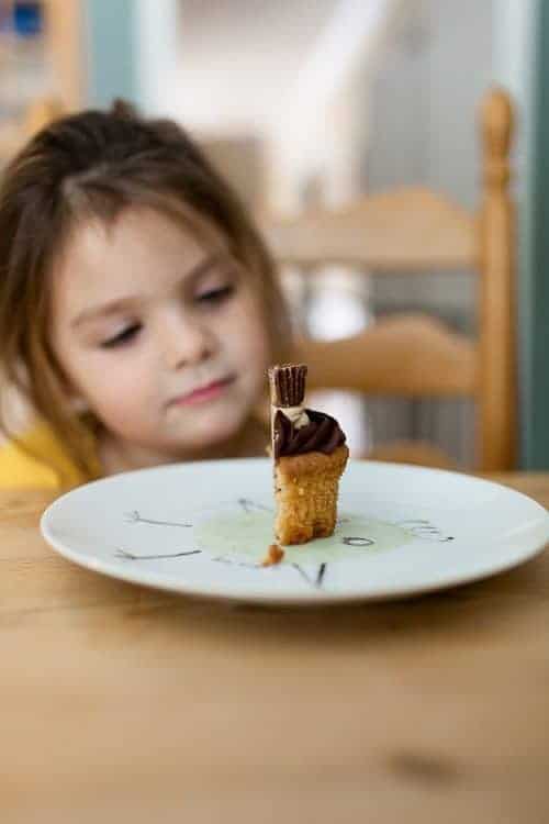 Little girl looking at a cupcake. Snacking trends among children by Jill Castle, MS, RDN