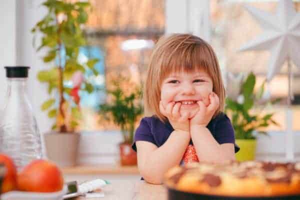 smiling toddler ready for a healthy snack