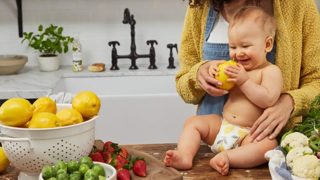 baby smiling at a lemon