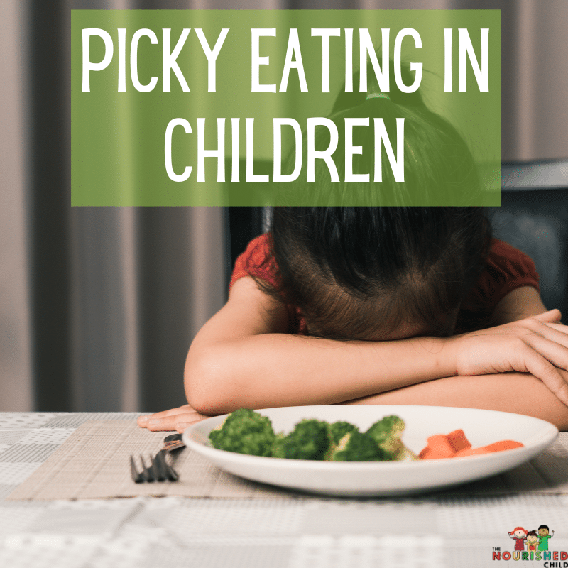 Picky eating in children - child with head on table next to a plate of vegetables